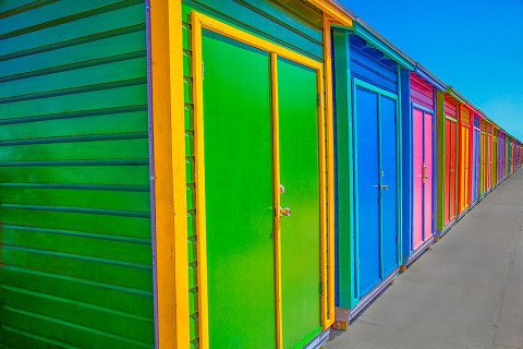 Architecture Bahamas Beach huts row in bright colors fading into the distance