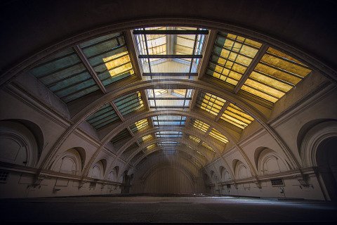 Old Vintage Hall theatre with sun light beams through windows and arches