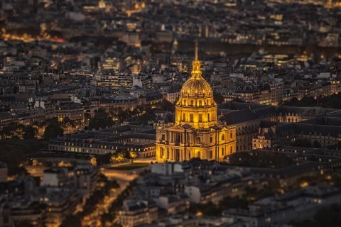 Les Invalides in Paris and City rooftops at night with lights