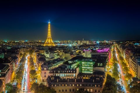 Paris city, boulevard streets and Eiffel Tower at sunset ights view from Arc De Triomphe