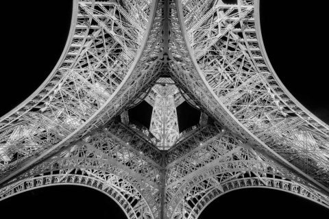 Abstract view of Eiffel Tower metalwork from below in black and white