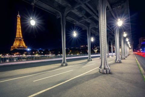 Paris Pont Bir Hakeim Bridge at night with car trails and eiffel tower