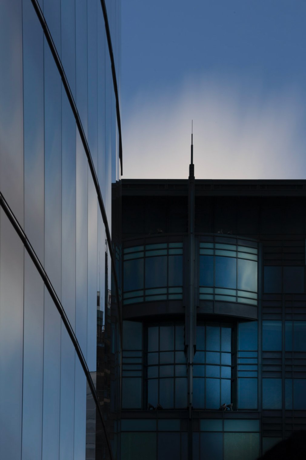 Long-exposure architectural photograph from London combining modern geometry and a softened sky.