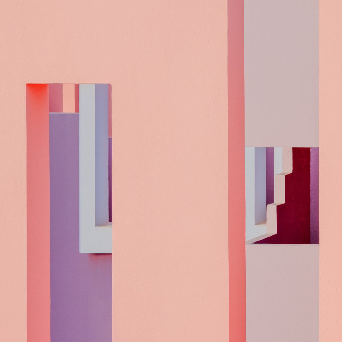 Pastel pink facade with narrow purple and blue vertical recesses.