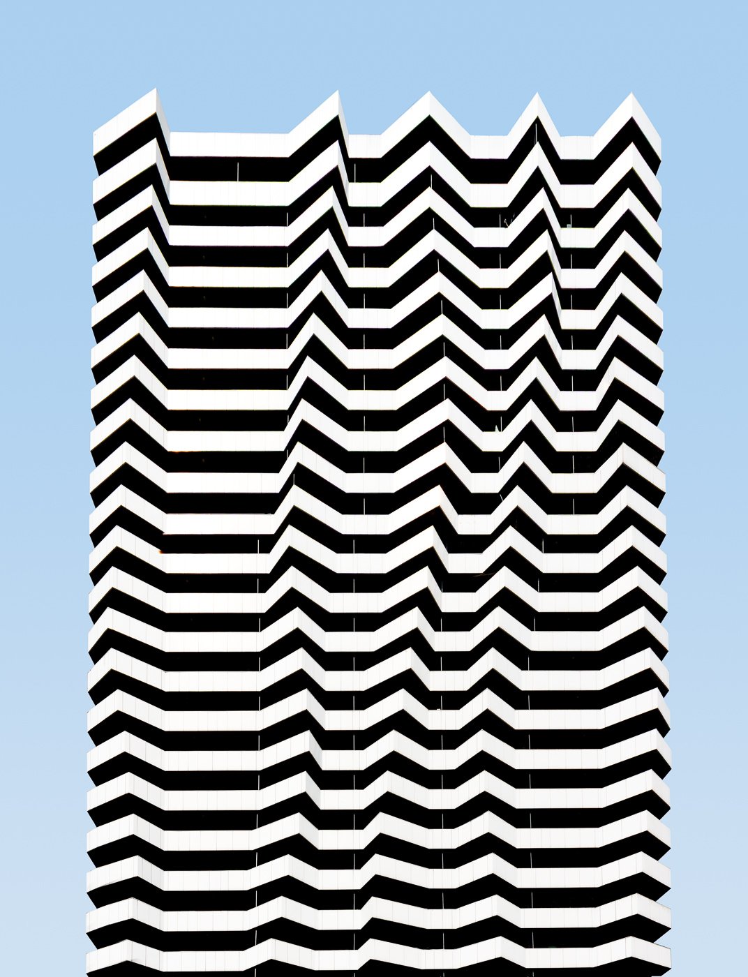 Black-and-white zigzag pattern across a modern building facade.
